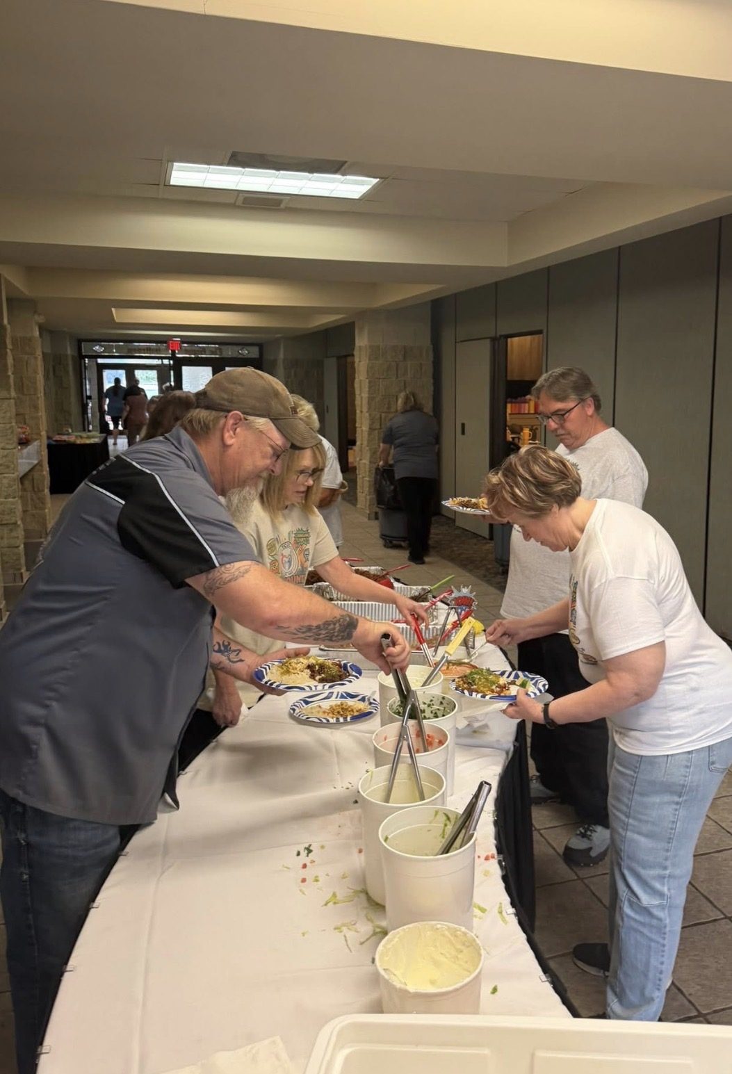 Guests being served at a Diaz Catering buffet line