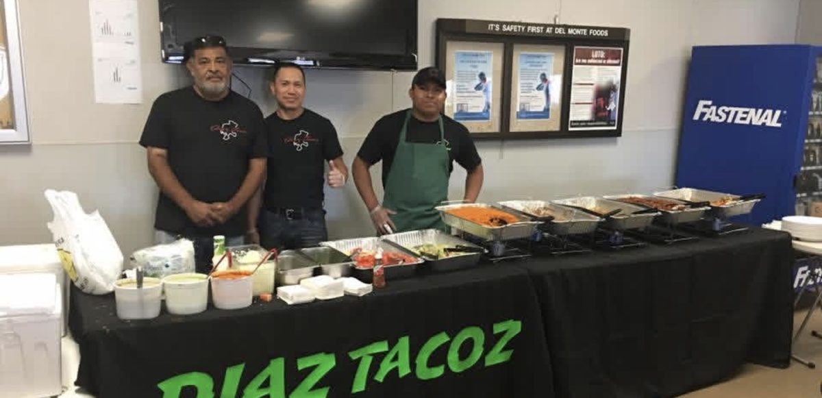 Diaz Tacoz catering staff at a full buffet setup with chafing dishes